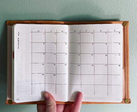 A calendar with boxes for a monthly spread